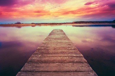 old wooden pier. calm river nature background. toned instant filtered photo image