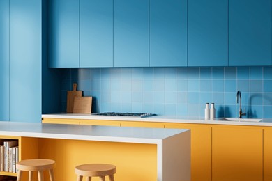 contemporary kitchen interior with bright blue cabinets and yellow drawers, minimal wooden stools and accessories, clean background, modern concept, 3d rendering