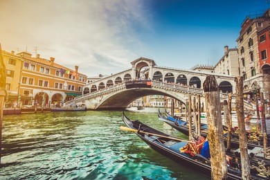 panoramic view of famous canal grande with famous rialto bridge at sunset in venice, italy with retro vintage instagram style filter effect