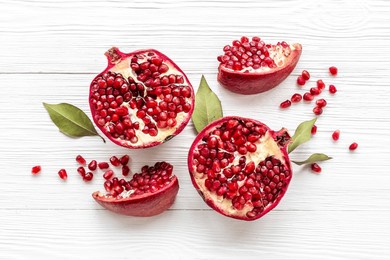 top view of fresh ripe pomegranate with half and pieces ready for eating.