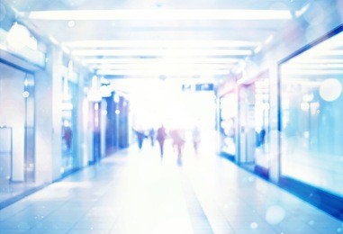 blur store with bokeh background. silhouettes of business people in blurred motion walking. business people walking in the office corridor.