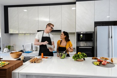 happy caucasian couples enjoy cooking together in modern kitchen, sweet husband and wife preparing meal in kitchen, couple cooking and family relationship happiness concept
