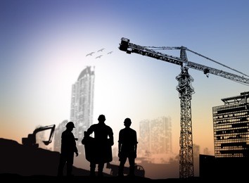 silhouette man engineer looking at blueprints blurred construction site