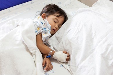 children sick sleeping on the bed at the hospital