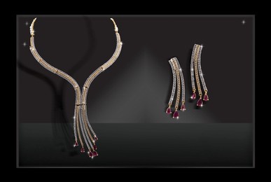 elegant diamond necklace set with ruby drop accents and matching long earrings, radiating luxury and sophistication against a black backdrop.