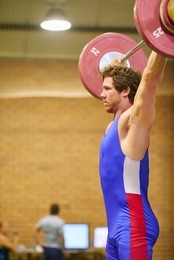 a weight lifter lifting weights during a competition