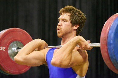 a weight lifter lifting weights during a competition