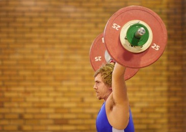 a weight lifter lifting weights during a competition