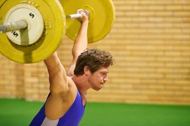 a weight lifter lifting weights during a competition