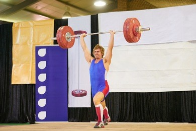 a weight lifter lifting weights during a competition