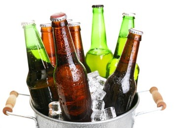 glass bottles of beer in metal bucket isolated on white