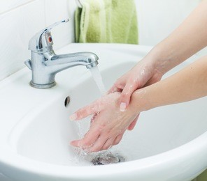 washing hands with streaming water in bathroom. hygiene 