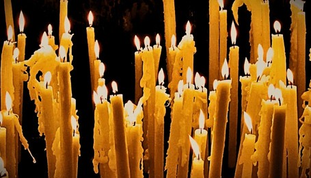 burning religious candles at lourdes, france