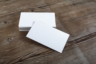 photo of blank business cards on a wooden background. template for id. top view.