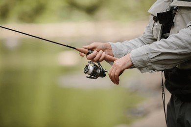 fisherman holding a fishing rod, savoring a tranquil day while casting for trout in a serene river surrounded by nature's beauty