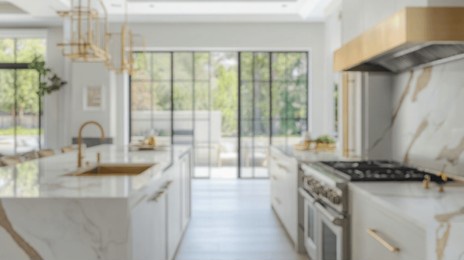 blurred background of stunning luxury kitchen featuring elegant marble accents and modern appliances. this spacious design invites natural light