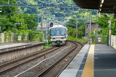 the jr west 283 series "ocean arrow" kuroshio express train at a rural station platform in the japanese countryside
