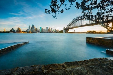 opera house and harbor bridge at sunset time.