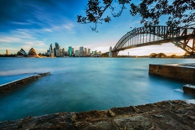 opera house and harbor bridge at sunset time.