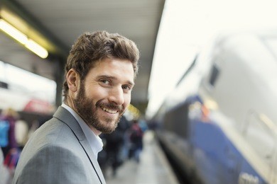 portrait of cheerful man on platform station. looking camera