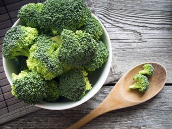 raw broccoli on wooden background