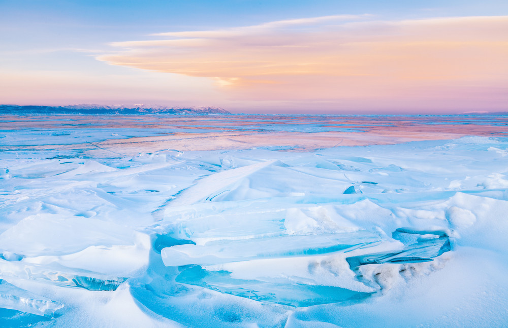 blue ice-drift at the sunset. baikal lake, russia