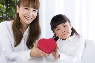 little girl has a gift box in her hand