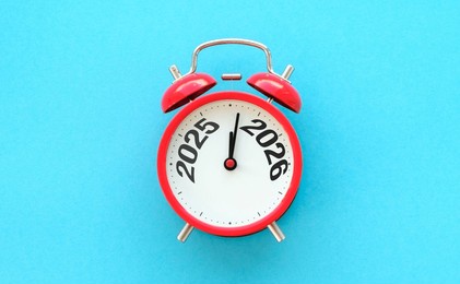 happy new year with red alarm clock and 2025 change to 2026 number. merry christmas, new start, resolution, countdown, goals, plan, action and mission concept