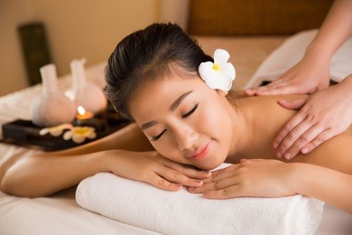 asian woman having massage and spa salon beauty treatment concept. she is very happy
