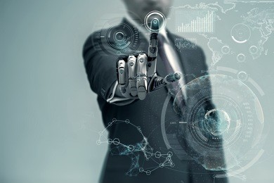 businessman with artificial robotic hand working on virtual holographic interface. future technology as design concept.