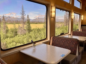 interior of alaska railroad scenic train dining car with table on beautiful clear day