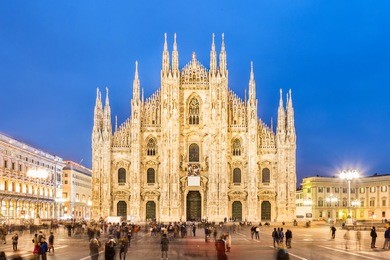 milan cathedral, duomo di milano, is the gothic cathedral church of milan, italy. shot in the dusk from the square ful of people.
