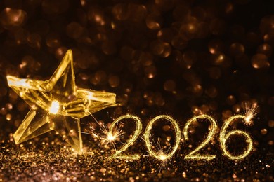 new year card concept for 2026 with sparkler numbers and glitter. glittery background, symbolizing festive new year vibes