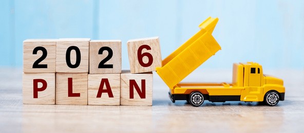 2026 plan cube blocks with miniature truck or construction vehicle. new start, vision, resolution, goal, industrial, warehouse and happy new year concept