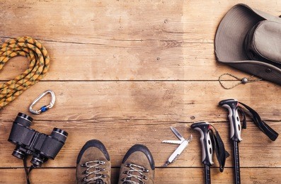 equipment for hiking on a wooden floor background
