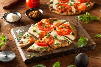 homemade margarita flatbread pizza with tomato and basil