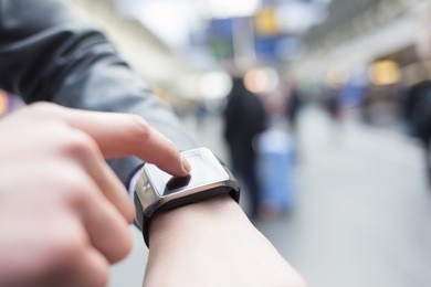 in hall station a man using his smart watch app. close-up hands