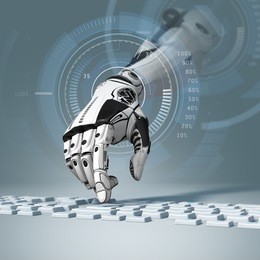 conceptual technology design. robotic arm working with computer keyboard. closeup image and depth of field