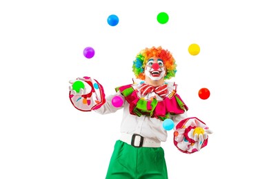 funny juggler clown juggling balls in the circus, man entertainer as joker in a suit and wig, with clown whiteface makeup. trickster, jester, pantomime, mime, and a professional actor at events