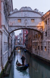 gondolas floating on canal towards bridge of sighs (ponte dei sospiri). venice, italy