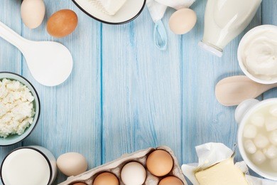 dairy products on wooden table. sour cream, milk, cheese, egg, yogurt and butter. top view with copy space