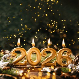 holiday background happy new year 2026. numbers of year 2026 made by gold burning candles on bokeh festive sparkling background. celebrating new year holiday, close-up. space for text