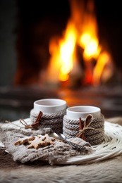 mulled wine with cinnamon stick by the fireplace