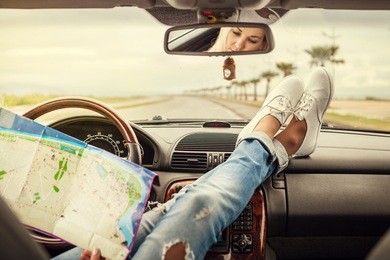 young woman alone car traveler with map 