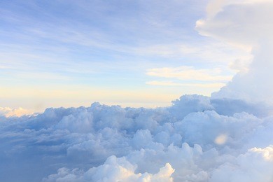 clouds and sky as seen through window of an aircraft