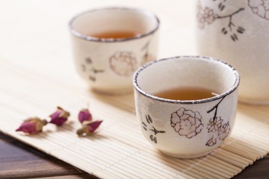 asian tea set on bamboo mat,closeup.
