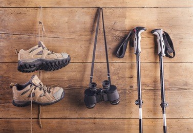 equipment for hiking hang on a wooden fence background