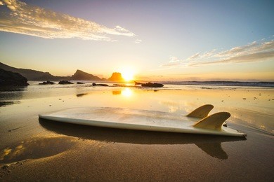 silhouette of a surfboard at the beach with reflection 