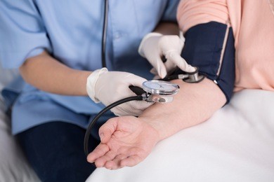 close-up of nurse using blood pressure meter 
