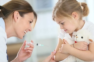 brave little girl receiving injection in doctor's office